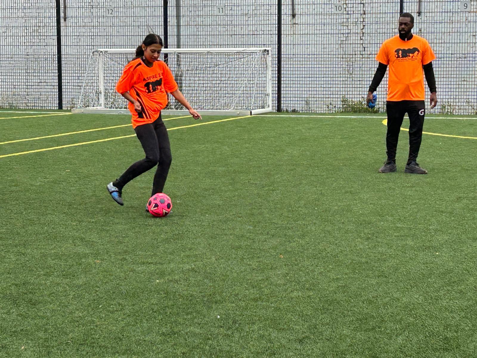 Young person taking a shot during an Aspire 2 B football session